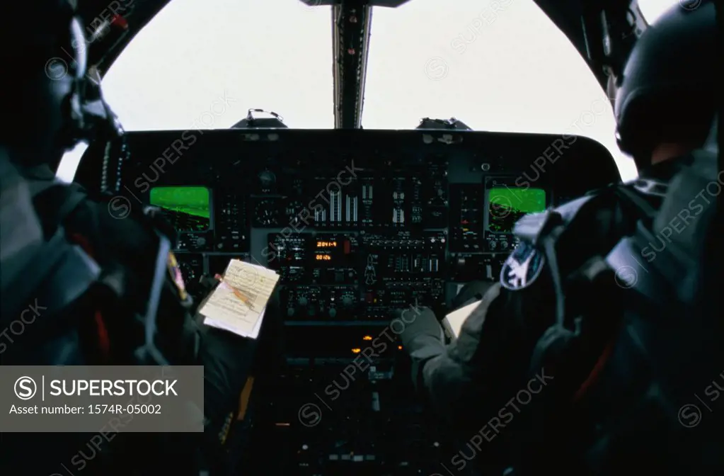 Rear view of two fighter pilots in a B-1B aircraft cockpit