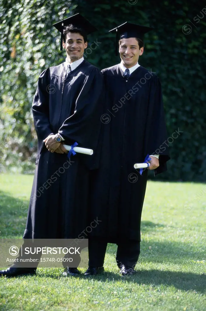Two male graduates smiling