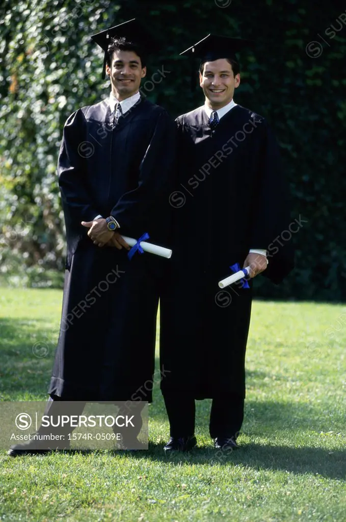 Two male graduates smiling
