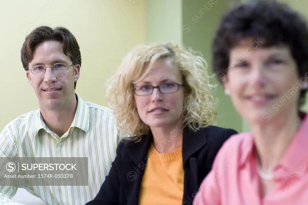 Portrait of a businessman and two businesswomen in an office