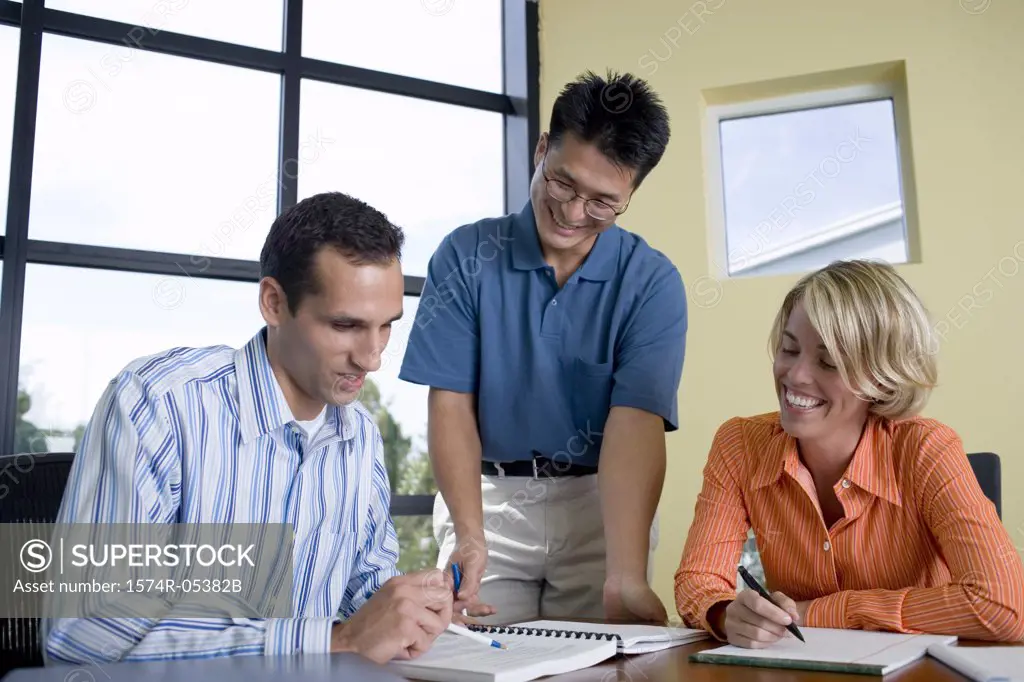 Businesswoman and two businessmen in an office