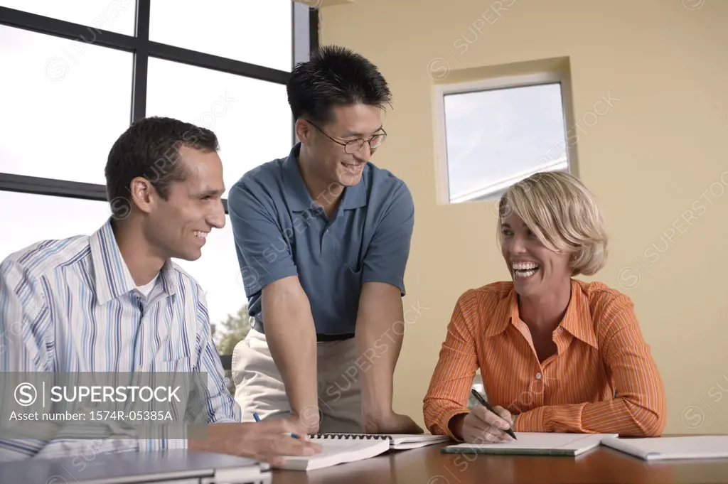 Businesswoman and two businessmen in an office