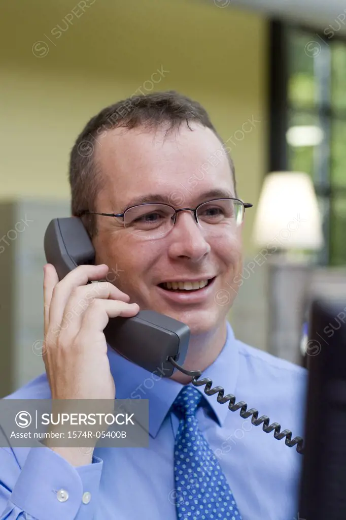 Businessman talking on a telephone in an office