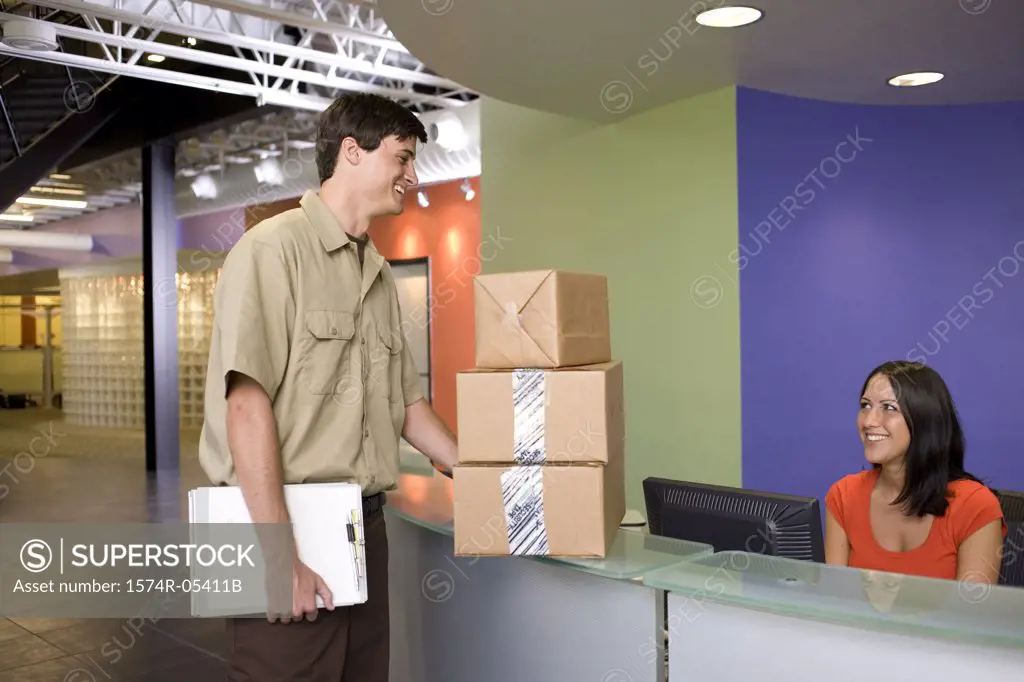 Receptionist receiving a package from a delivery man