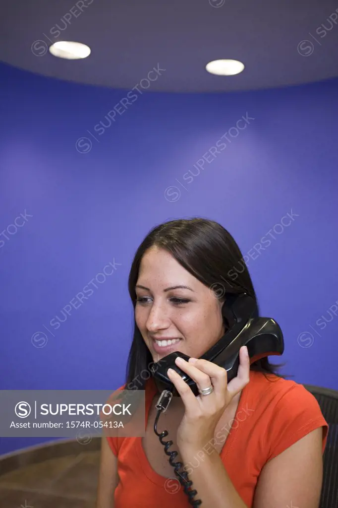 Businesswoman talking on a telephone in an office