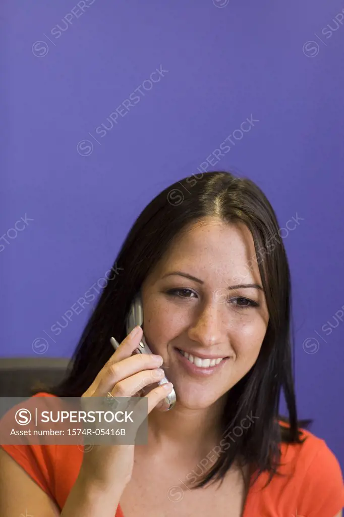 Close-up of a businesswoman talking on a mobile phone in an office