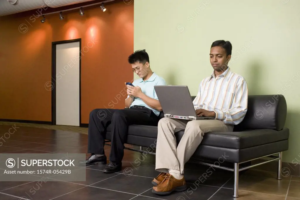 Two businessmen sitting on a couch
