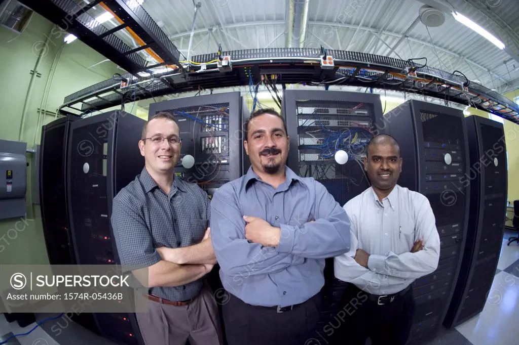 Portrait of three technicians standing in a server room