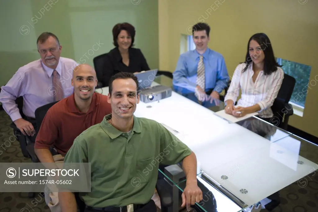 Portrait of a group of business executives sitting around a conference table