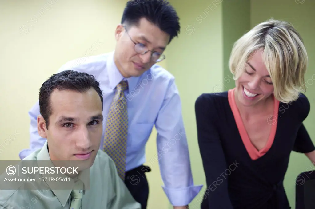 Two businessmen and a businesswoman in a meeting