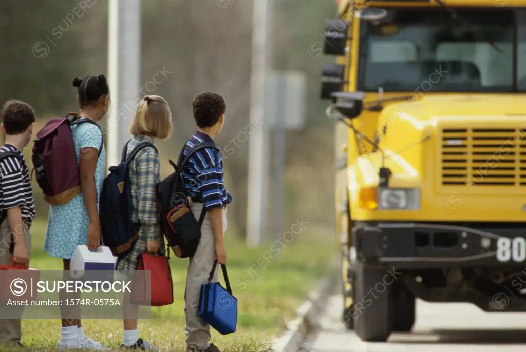 School children standing in line outside the school bus