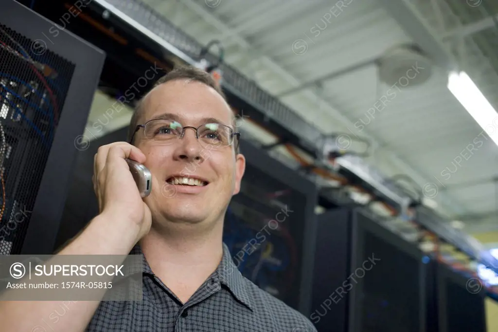 Close-up of a male technician talking on a mobile phone