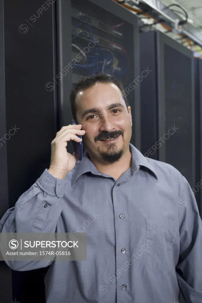 Portrait of a male technician talking on a mobile phone