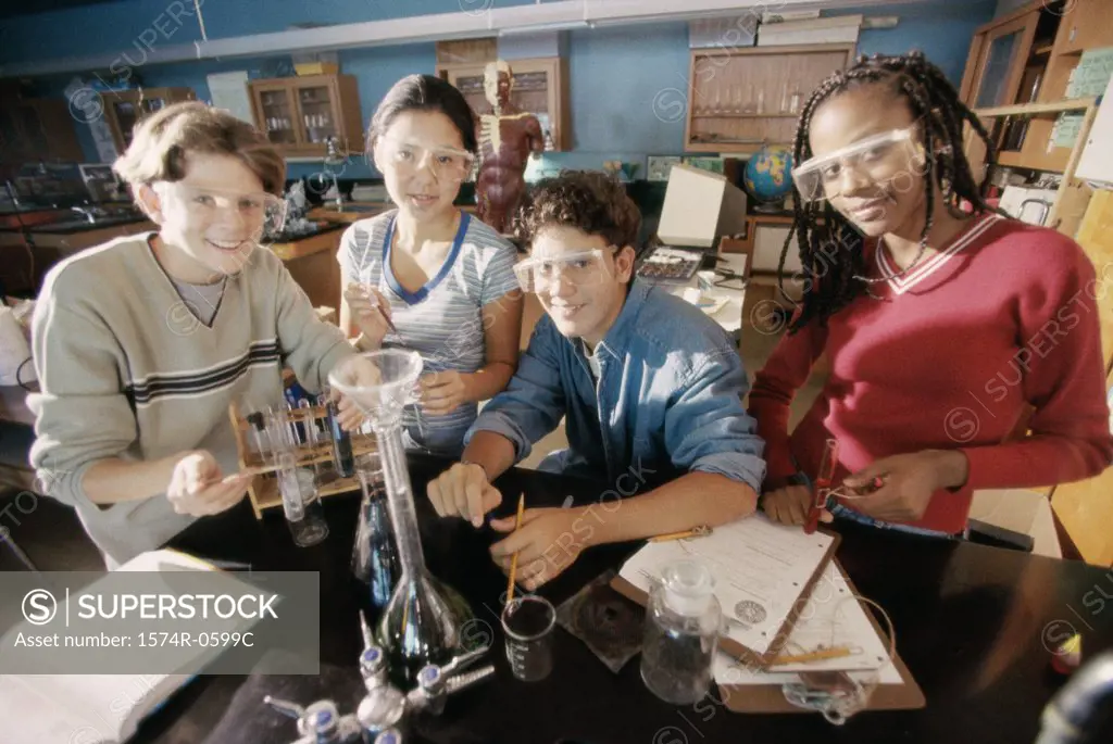 Portrait of two teenage boys and two teenage girls in a science laboratory