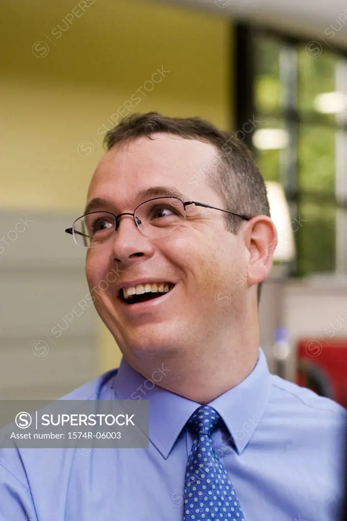 Close-up of a businessman laughing in an office
