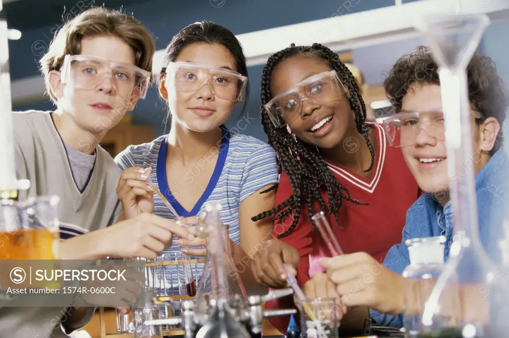 Portrait of two teenage boys and two teenage girls in a science laboratory