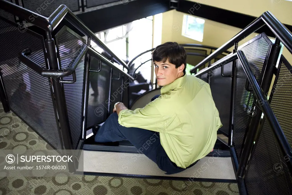 Portrait of a businessman sitting on stairs