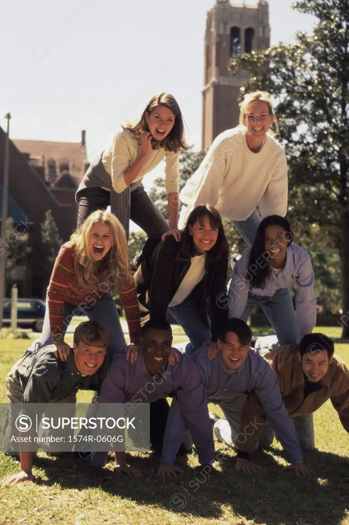 Group of young people making a human pyramid