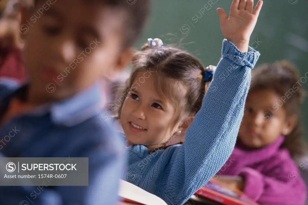 Girl raising her hand in class