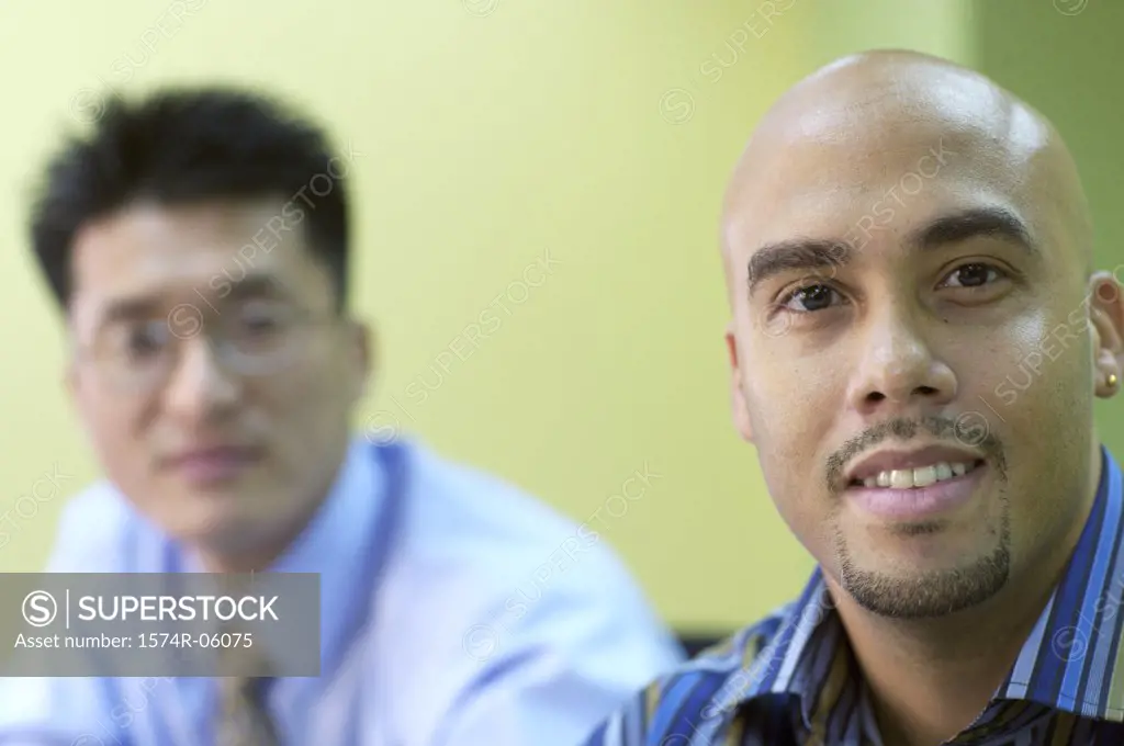 Portrait of two businessmen sitting in a conference room