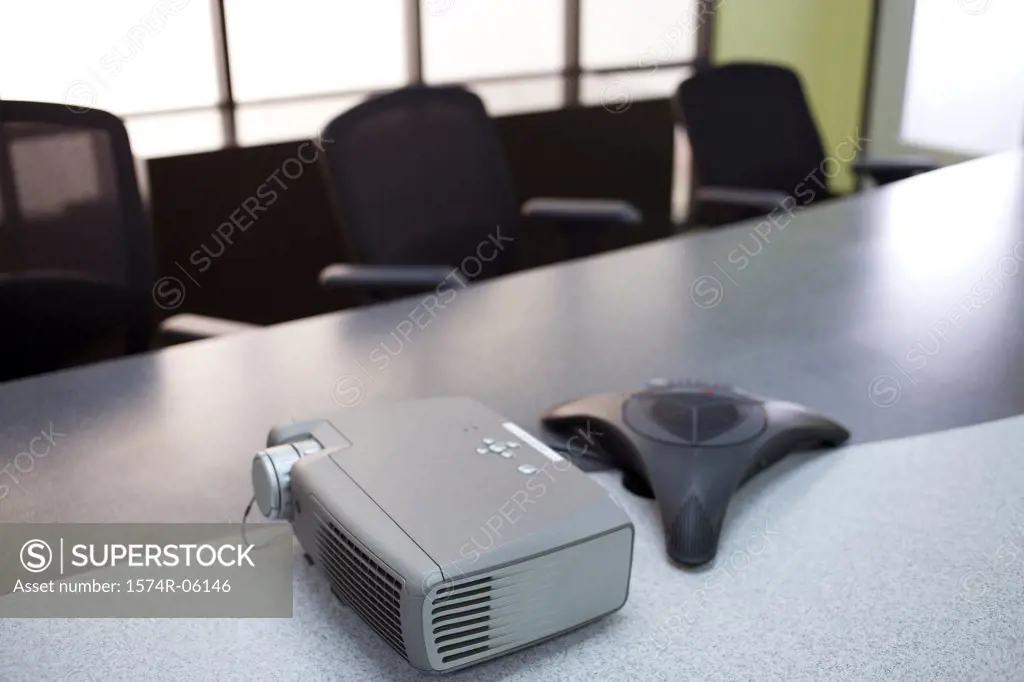 Slide projector and a conference phone on the table in a boardroom