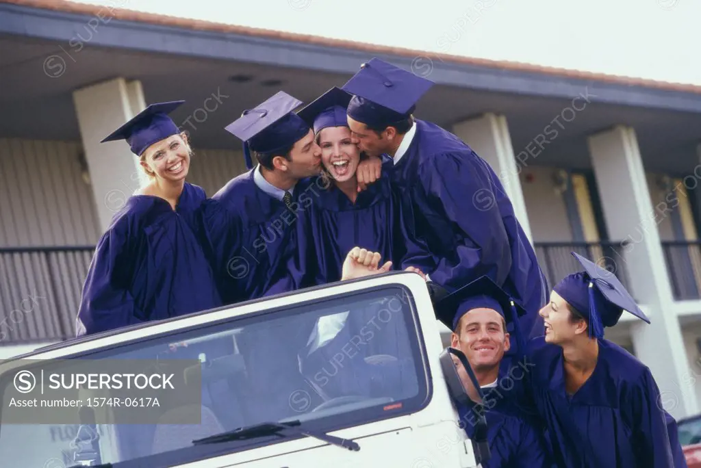 Group of graduates in a jeep