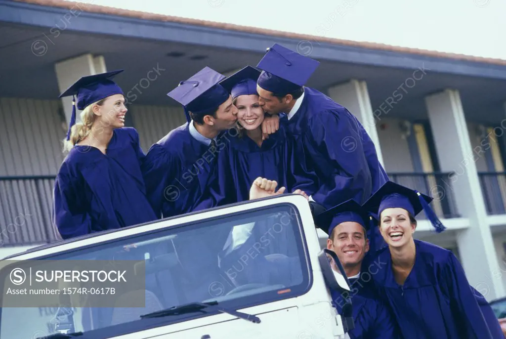 Group of graduating students sitting in an all terrain vehicle