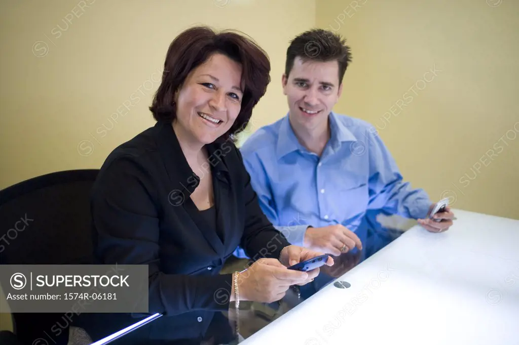 Portrait of a businessman and a businesswoman sitting in an office