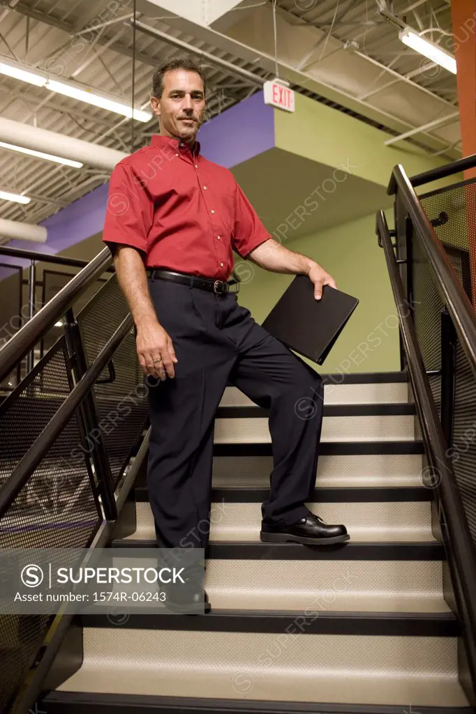 Low angle view of a businessman standing on a staircase