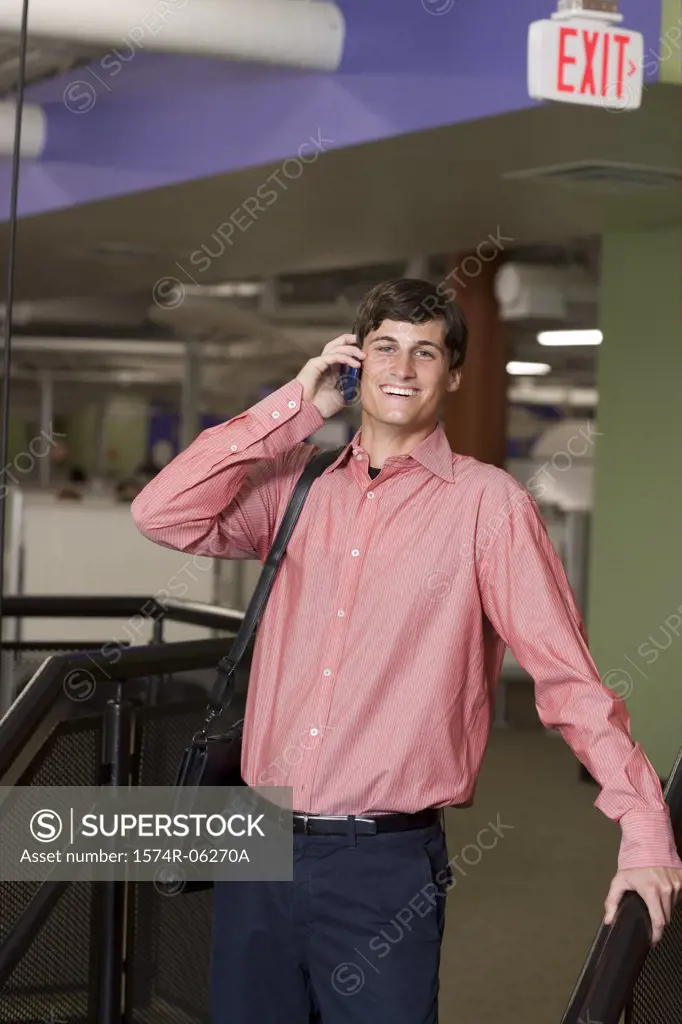 Portrait of a businessman talking on a mobile phone in an office