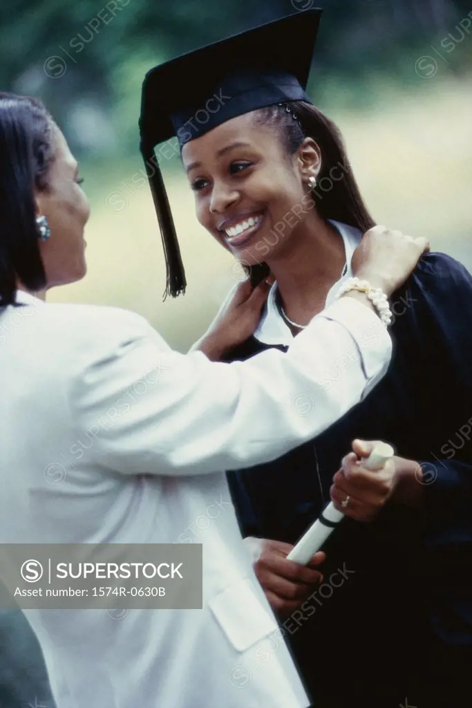 Female graduate standing with her mother