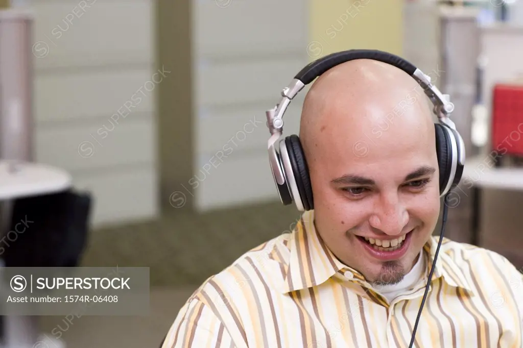 Close-up of a businessman wearing headphones in an office