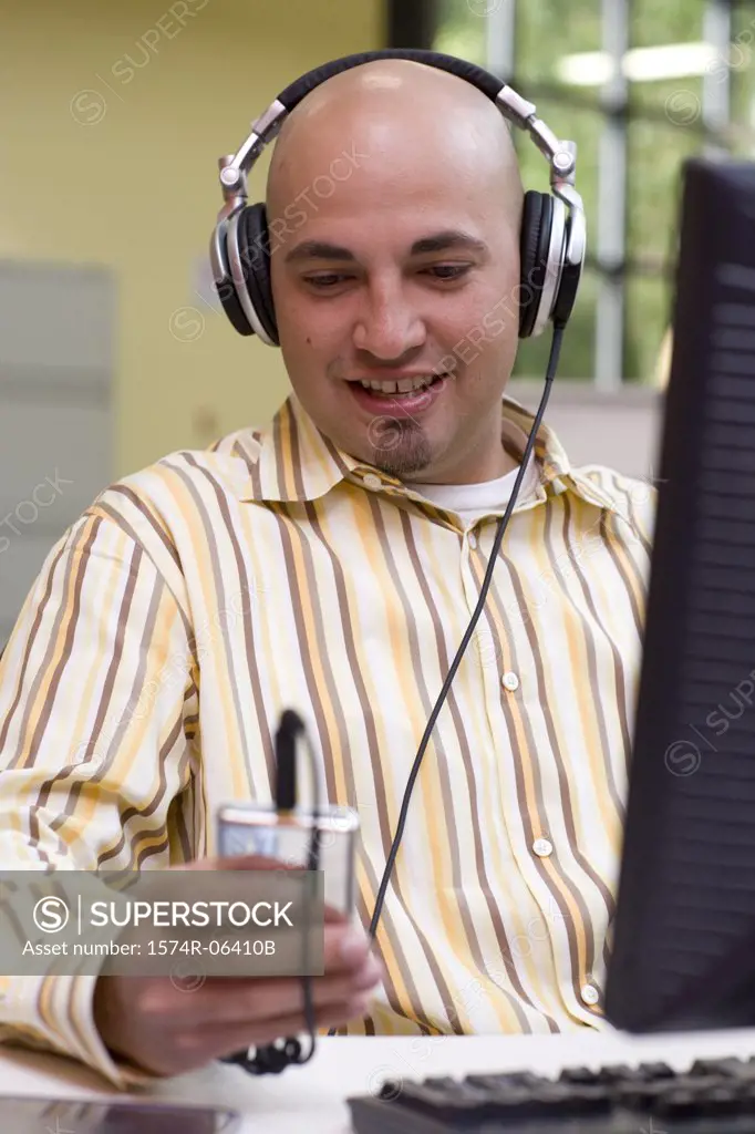 Businessman wearing headphones in an office