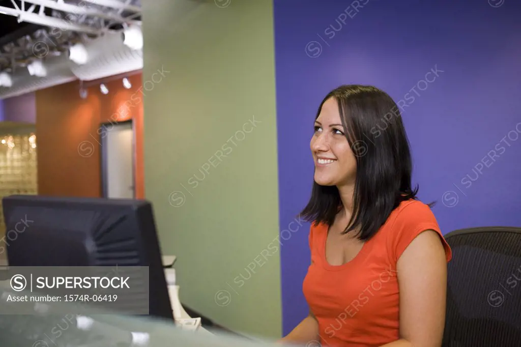 Side profile of a businesswoman sitting in front of a computer