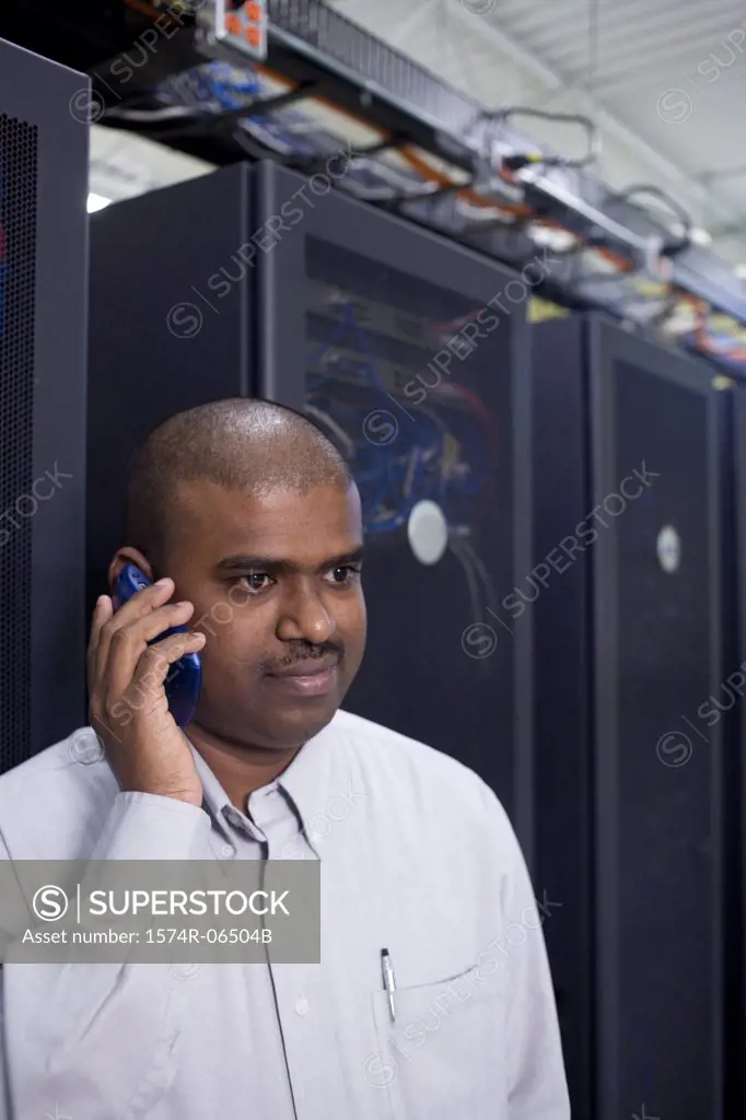 Close-up of a technician talking on a mobile phone