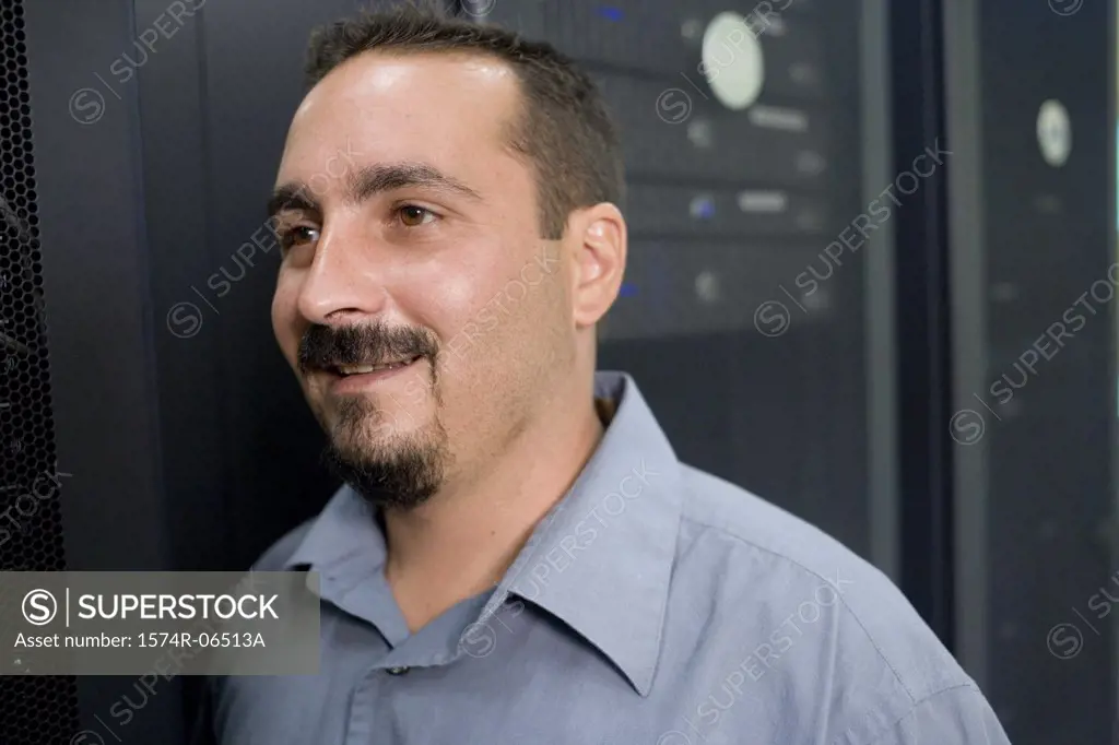 Close-up of a technician smiling in a server room