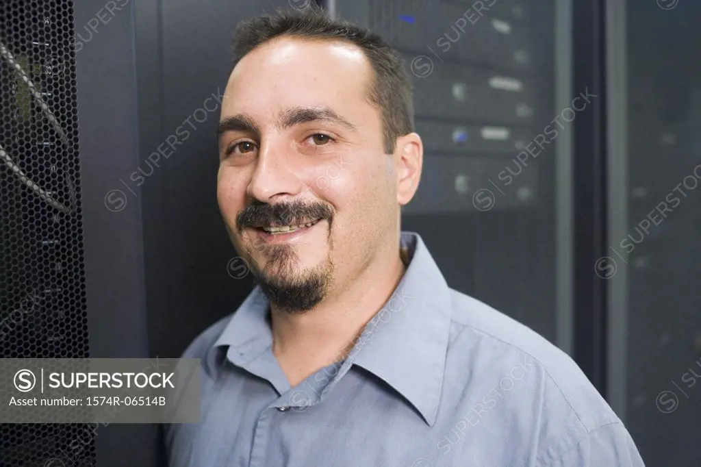 Portrait of a technician smiling in a server room