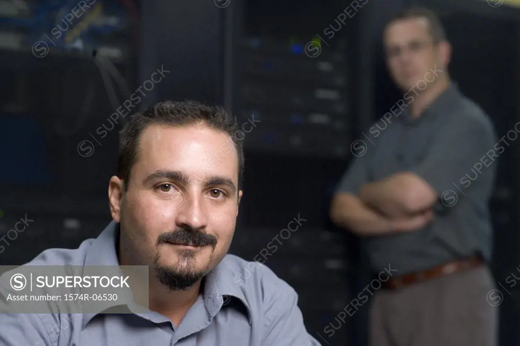 Portrait of two technicians in a server room