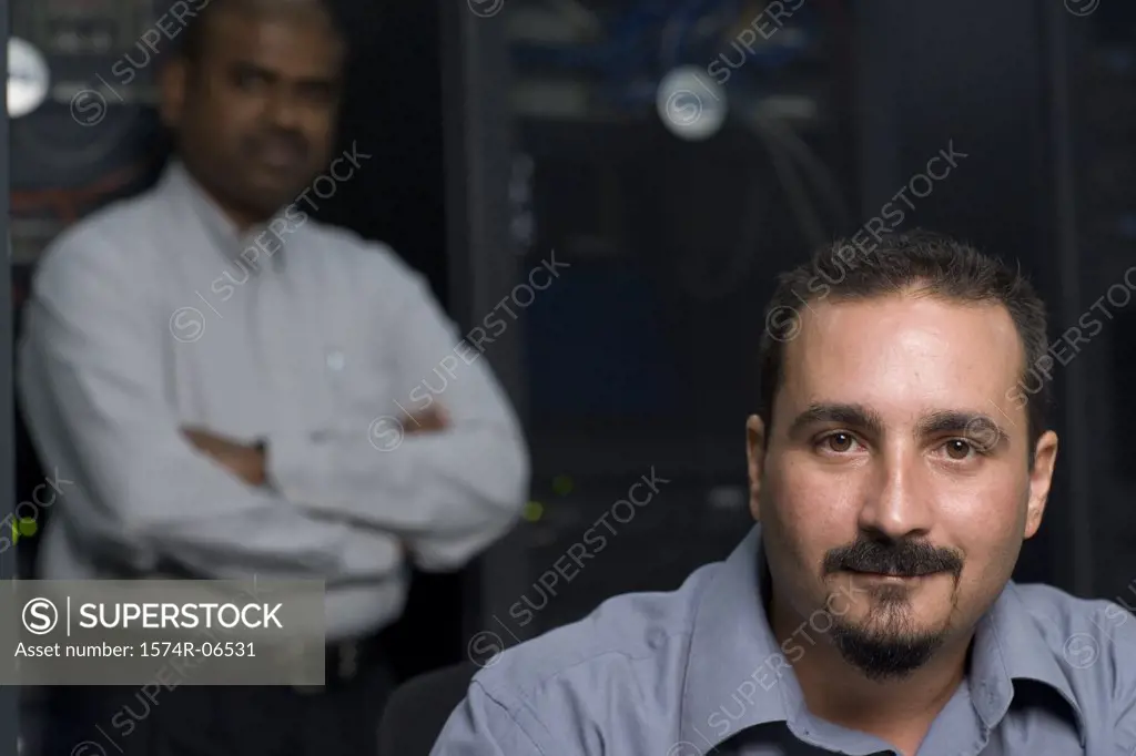 Portrait of two technicians in a server room