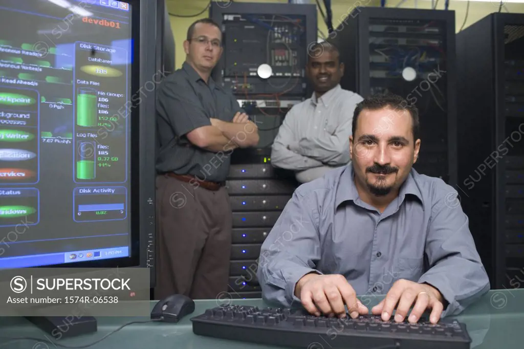 Portrait of three technicians in a server room