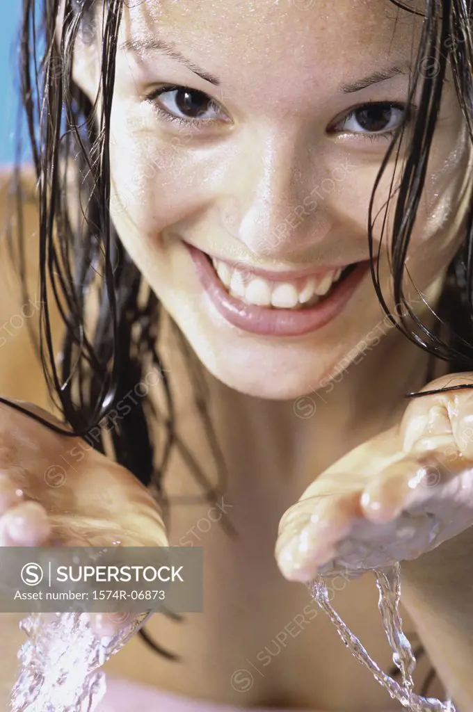 Close-up of a young woman washing her face