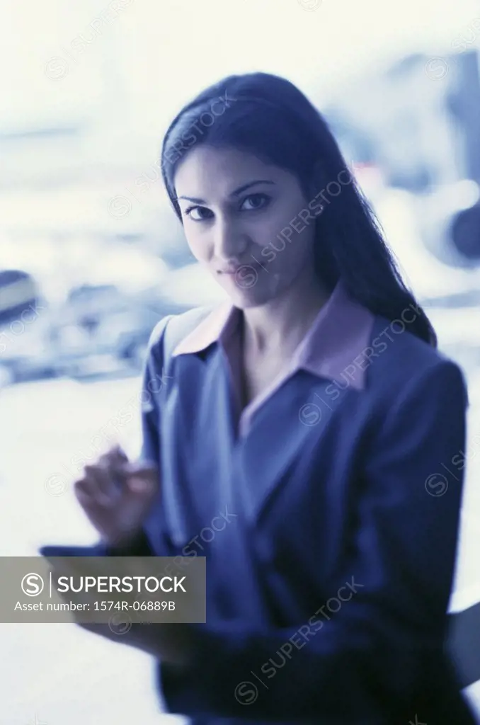 Portrait of a businesswoman operating a hand held device