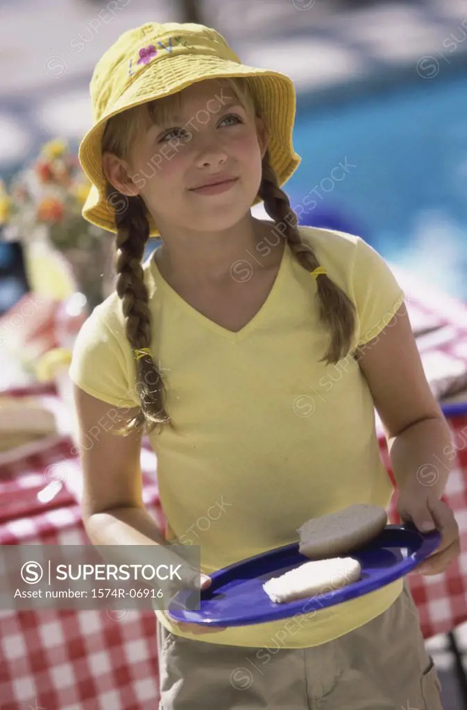 Girl holding a plate with a bread bun