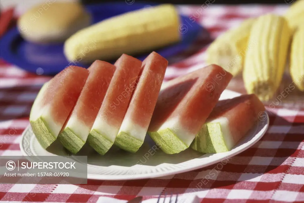 Close-up of watermelon slices on a plate on a picnic table