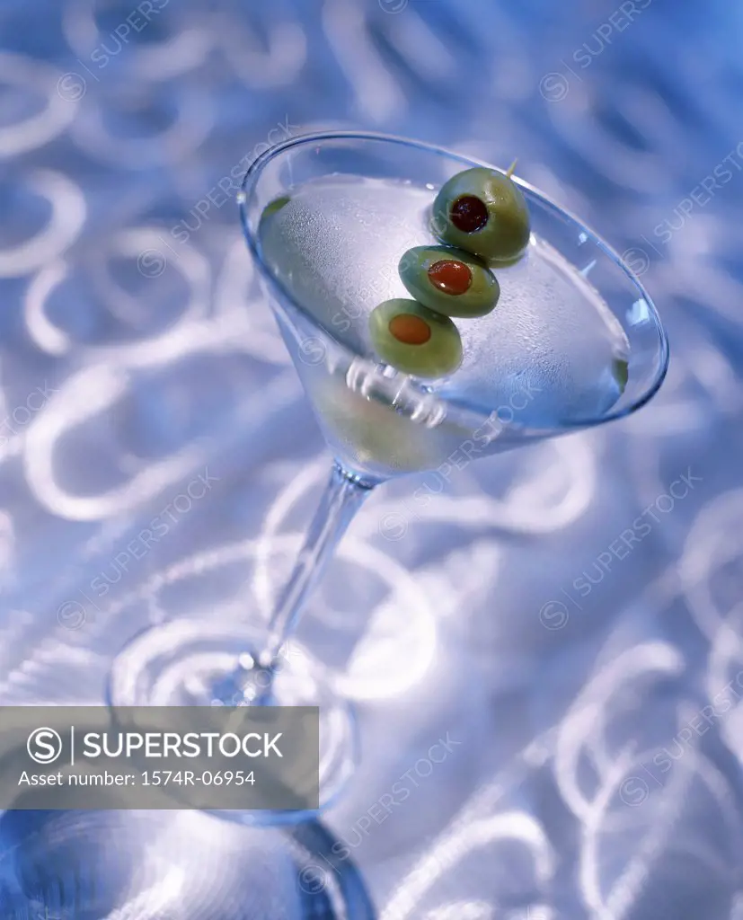 Green olives in a martini glass