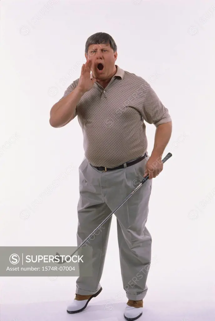 Portrait of a man standing holding a golf club and shouting