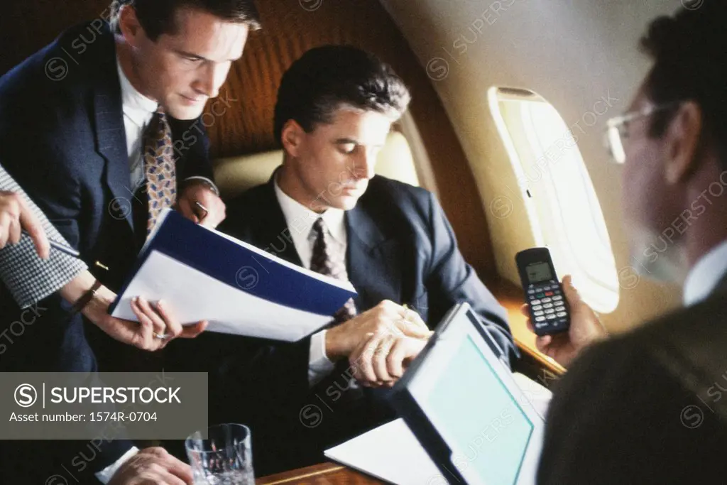 Business executives discussing in a commercial airplane