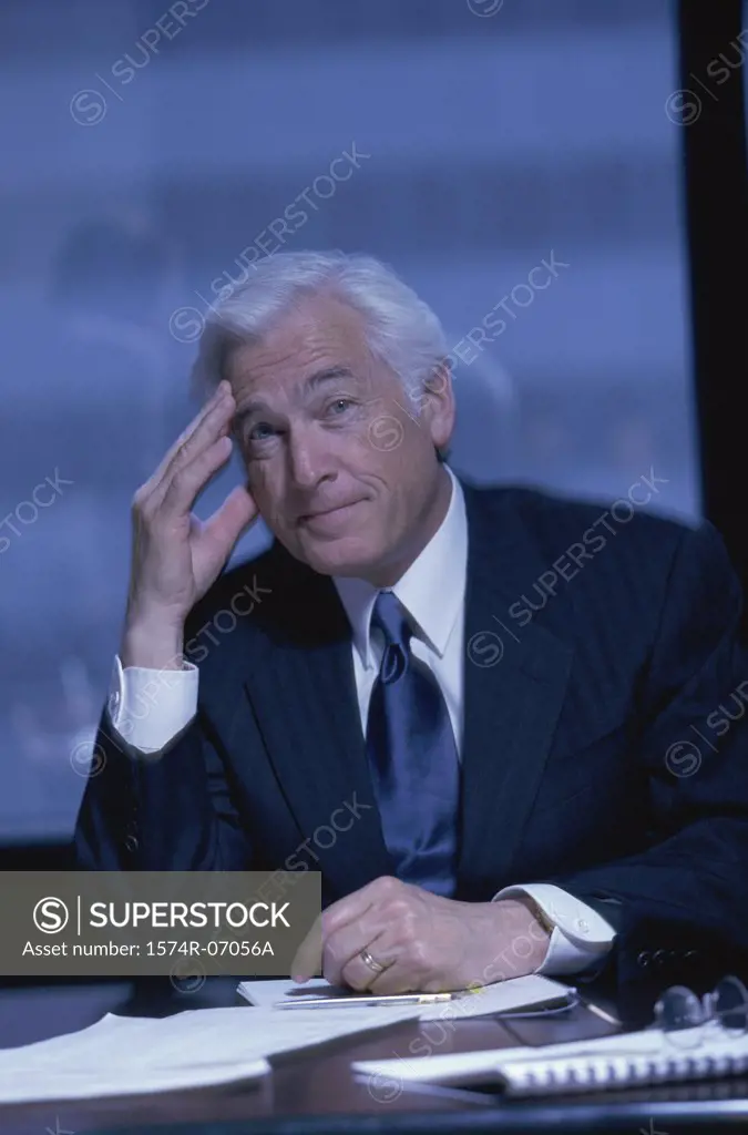 Portrait of senior businessman seated at an office desk