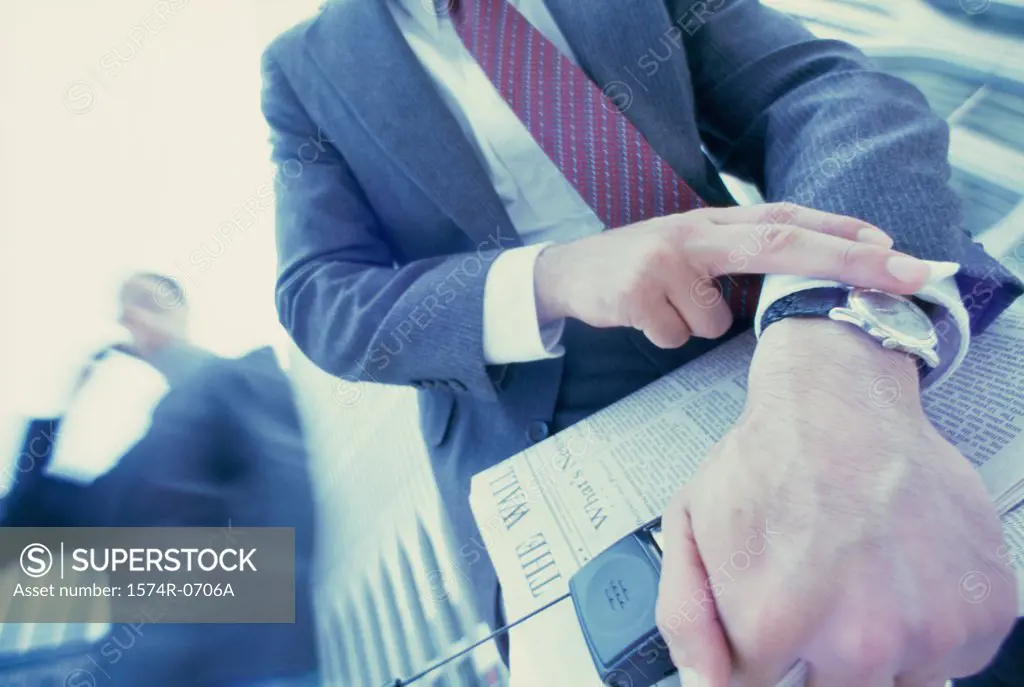 Low angle view of a businessman looking at his wristwatch