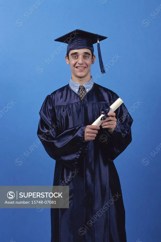 Young male graduate holding a diploma